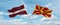 two crossed flags Macedonia and Latvia waving in wind at cloudy sky. Concept of relationship, dialog, travelling between two