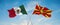 two crossed flags Macedonia and mexico waving in wind at cloudy sky. Concept of relationship, dialog, travelling between two