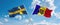 two crossed flags Moldova and Sweden waving in wind at cloudy sky. Concept of relationship, dialog, travelling between two