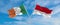 two crossed flags Monaco and Ireland waving in wind at cloudy sky. Concept of relationship, dialog, travelling between two