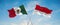 two crossed flags Monaco and mexico waving in wind at cloudy sky. Concept of relationship, dialog, travelling between two