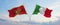 two crossed flags Montenegro and Italy waving in wind at cloudy sky. Concept of relationship, dialog, travelling between two