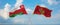 two crossed flags Montenegro and Oman waving in wind at cloudy sky. Concept of relationship, dialog, travelling between two