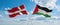 two crossed flags Palestine and Denmark waving in wind at cloudy sky. Concept of relationship, dialog, travelling between two