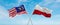 two crossed flags poland and Malaysia waving in wind at cloudy sky. Concept of relationship, dialog, travelling between two