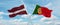 two crossed flags portugal and Latvia waving in wind at cloudy sky. Concept of relationship, dialog, travelling between two