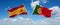 two crossed flags portugal and spain waving in wind at cloudy sky. Concept of relationship, dialog, travelling between two