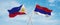 two crossed flags Republic Srpska and Philippines waving in wind at cloudy sky. Concept of relationship, dialog, travelling