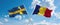 two crossed flags romania and Sweden waving in wind at cloudy sky. Concept of relationship, dialog, travelling between two