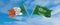 two crossed flags Saudi Arabia and Ireland waving in wind at cloudy sky. Concept of relationship, dialog, travelling between two