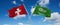 two crossed flags Saudi Arabia and Switzerland waving in wind at cloudy sky. Concept of relationship, dialog, travelling between