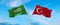 two crossed flags Saudi Arabia and Turkey waving in wind at cloudy sky. Concept of relationship, dialog, travelling between two