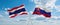 two crossed flags Slovakia and Thailand waving in wind at cloudy sky. Concept of relationship, dialog, travelling between two