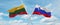 two crossed flags Slovenia and Lithuania waving in wind at cloudy sky. Concept of relationship, dialog, travelling between two