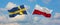 two crossed flags SWEDEN and Poland waving in wind at cloudy sky. Concept of relationship, dialog, travelling between two