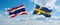 two crossed flags SWEDEN and Thailand waving in wind at cloudy sky. Concept of relationship, dialog, travelling between two