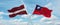 two crossed flags Taiwan and Latvia waving in wind at cloudy sky. Concept of relationship, dialog, travelling between two