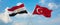 two crossed flags Turkey and Egypt waving in wind at cloudy sky. Concept of relationship, dialog, travelling between two countries