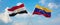 two crossed flags Venezuela and Egypt waving in wind at cloudy sky. Concept of relationship, dialog, travelling between two