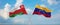 two crossed flags Venezuela and Oman waving in wind at cloudy sky. Concept of relationship, dialog, travelling between two