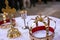 Two crowns and cross on white table prepared for wedding. Orthodox church wedding accessories