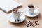 Two cup of turkish coffee close-up on a wooden background, coffee beans. Pleasant morning and cheerfulness