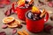 Two cups of autumn mulled wine or gluhwein with spices and orange slices on rustic table top view. Traditional drink on autumn hol