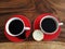 Two cups of black coffee drink background, cookies and raw coffee beans top view, high angle view. Fresh morning coffee concept.