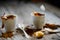 Two cups of coffee on beige doily on dark wood table