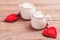 Two cups of coffee with decorative felt heart on wooden background close-up. The Concept Of Valentine`s Day, Christmas