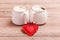 Two cups of coffee with decorative felt heart on wooden background close-up. The Concept Of Valentine`s Day, Christmas