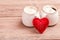 Two cups of coffee with decorative felt heart on wooden background close-up. The Concept Of Valentine`s Day, Christmas