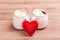 Two cups of coffee with decorative felt heart on wooden background close-up. The Concept Of Valentine`s Day, Christmas