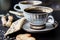 Two cups of coffee with puff pastries with sunflower seeds, sesame seeds and flax.Small depth of focus