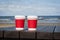 Two cups of coffee on the seacoast beach for a couple in love