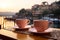 Two cups of coffee on a table of outdoor restaurant in small seaside town in Italy. Having breakfast coffee in Italian scenery on