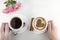 Two cups of coffee on a white background with hands, roses hands