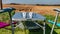 Two cups with Dutch decoration on a metal table with two camping chairs next to a cultivated field