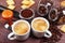 Two cups of espresso, crackers, cookies, holder with ground coffee, tamper and coffee beans on wooden table