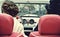 Two curly girl in medieval dress in vintage cars. Vintage style.