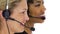 Two customer service women smiling with headsets