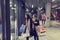 Two cute adolescent young women shopping on a cold winter evening, while holding large shopping bags