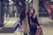 Two cute adolescent young women shopping on a cold winter evening, while holding large shopping bags