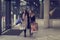 Two cute adolescent young women shopping on a cold winter evening, while holding large shopping bags