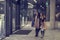 Two cute adolescent young women shopping on a cold winter evening, while holding large shopping bags