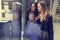 Two cute adolescent young women shopping on a cold winter evening, while holding large shopping bags