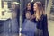 Two cute adolescent young women shopping on a cold winter evening, while holding large shopping bags