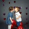 two cute adorable baby children toddlers kissing each other in studio
