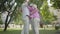Two cute adult couples hugging in the park together standing in circle. Double date of senior couples. Friendly company