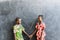 Two Cute African Girls Women Standing Together with Heart Love Symbol in Blackboard Background